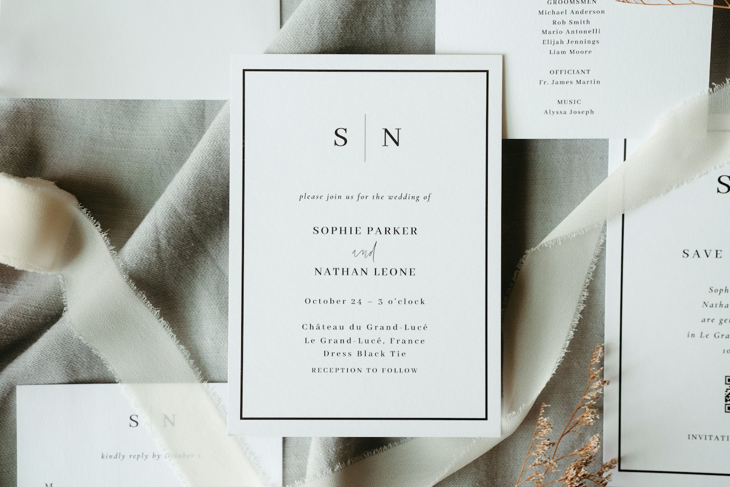 Elegant wedding invitations with silk ribbon and dried flowers.